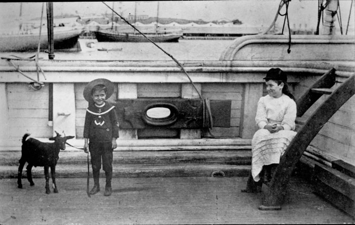 Children and pet goat aboard ship